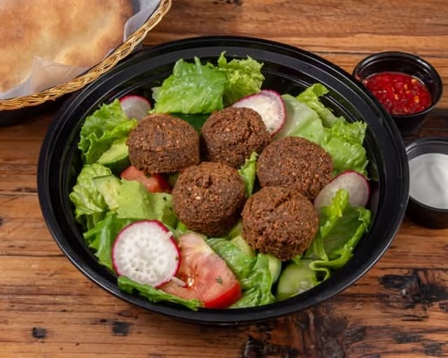 Falafel Over Salad and pita.